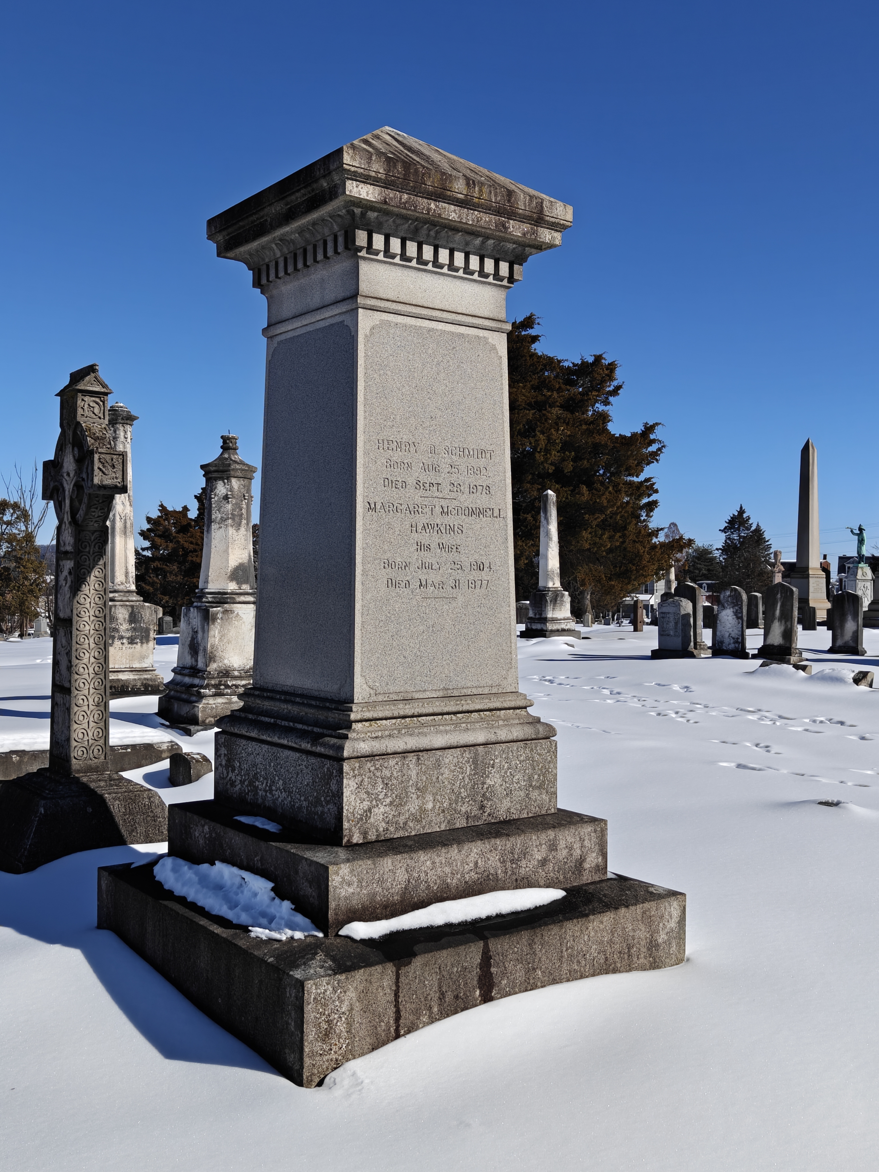 Three-quarter left view of the right side of the Henry D. Schmidt gravestone monument, with snow covering the foreground.