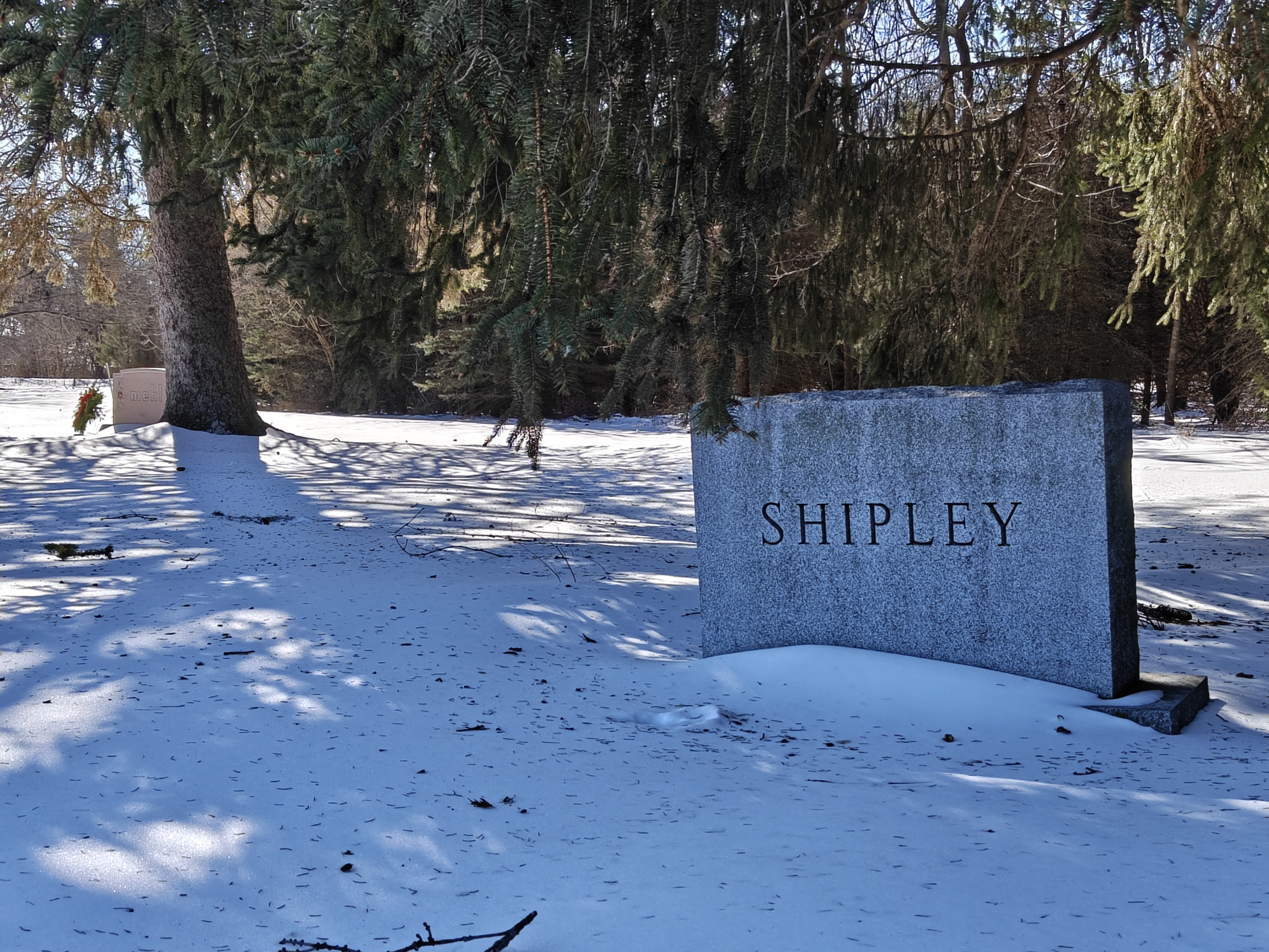 Front view of the Shiply family gravestone monument, with snow covering the foreground.